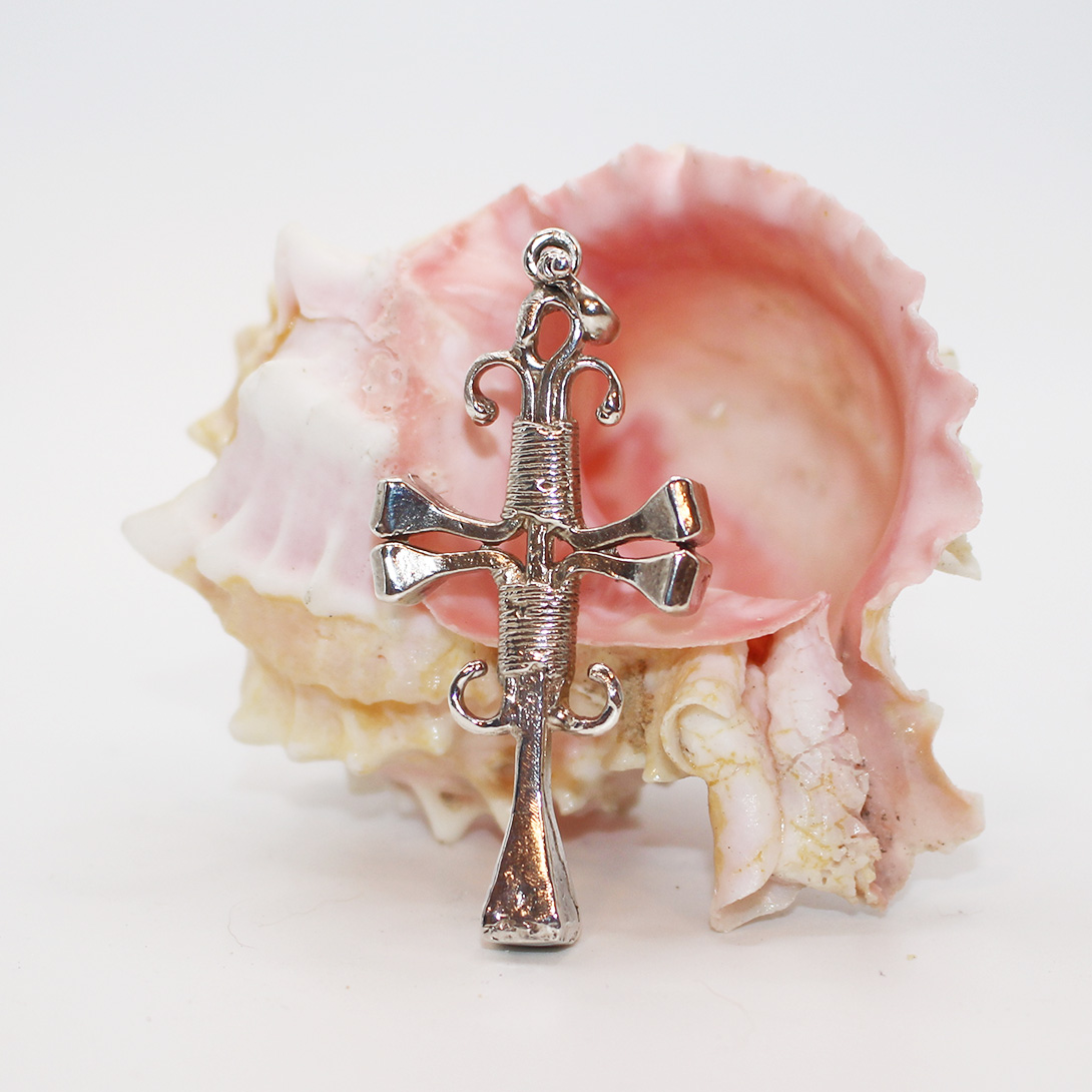 A silver cross pendant.