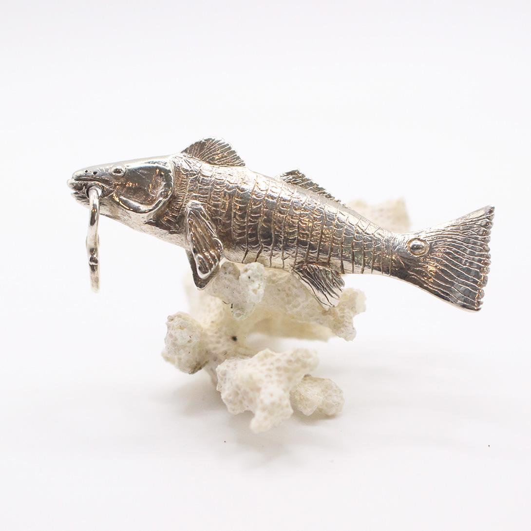 A silver red drum pendant.